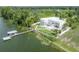 Stunning waterfront estate with a private dock, lush landscaping, and modern architectural design at 11313 Knights Griffin Rd, Thonotosassa, FL 33592