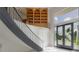 Elegant foyer with a curved staircase and decorative glass entry doors at 11313 Knights Griffin Rd, Thonotosassa, FL 33592