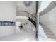 Bright foyer with a curved staircase, high ceilings, and stylish decor at 11313 Knights Griffin Rd, Thonotosassa, FL 33592