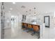 Modern kitchen features an oversized island with seating and modern pendant lighting at 11313 Knights Griffin Rd, Thonotosassa, FL 33592
