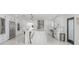 Gourmet kitchen featuring a marble island, stainless appliances, and sleek white cabinets at 11313 Knights Griffin Rd, Thonotosassa, FL 33592