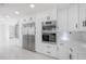 Gourmet kitchen features stainless steel appliances and modern white cabinetry at 11313 Knights Griffin Rd, Thonotosassa, FL 33592