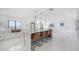 Bright, modern kitchen with an island, pendant lighting, barstools, and a stainless steel sink at 11313 Knights Griffin Rd, Thonotosassa, FL 33592