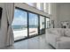 Living room showcasing expansive sliding glass doors to the pool and waterfront view at 11313 Knights Griffin Rd, Thonotosassa, FL 33592
