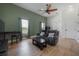 Inviting living room featuring comfortable seating and views through large windows at 11313 Knights Griffin Rd, Thonotosassa, FL 33592