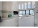 Bright living room with high ceilings, waterfront view and decorative fish tank at 11313 Knights Griffin Rd, Thonotosassa, FL 33592