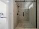 Shower room features marble tile walls, glass door and black fixtures at 11313 Knights Griffin Rd, Thonotosassa, FL 33592