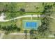 Overhead shot of a private tennis court on a large, well-maintained property at 11313 Knights Griffin Rd, Thonotosassa, FL 33592