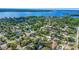 Expansive aerial view shows a residential community near a large body of water, surrounded by lush trees and green spaces at 1213 E Lemon St, Tarpon Springs, FL 34689