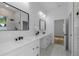 Bathroom features double sinks, black hardware, white cabinets, and modern mirrors at 1213 E Lemon St, Tarpon Springs, FL 34689