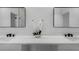 Bathroom features double sinks, black hardware, white cabinets, and quartz countertop at 1213 E Lemon St, Tarpon Springs, FL 34689