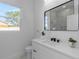 Clean and bright bathroom featuring a large mirror, white vanity, and natural lighting at 1213 E Lemon St, Tarpon Springs, FL 34689