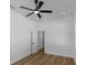 Bedroom showcasing a ceiling fan, a window, and an open doorway at 1213 E Lemon St, Tarpon Springs, FL 34689