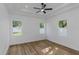 Bright bedroom with tray ceiling, ceiling fan, three windows, and beautiful floors at 1213 E Lemon St, Tarpon Springs, FL 34689