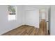 Bright bedroom featuring hardwood floors, natural light from a window, and a closet at 1213 E Lemon St, Tarpon Springs, FL 34689