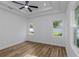 Bright bedroom with tray ceiling, ceiling fan, two windows, and beautiful floors at 1213 E Lemon St, Tarpon Springs, FL 34689