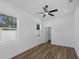 Bright bedroom with a ceiling fan, natural light, and modern wood floors at 1213 E Lemon St, Tarpon Springs, FL 34689