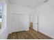 Bedroom with closet, window, light hardwood floors, and neutral paint at 1213 E Lemon St, Tarpon Springs, FL 34689