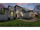 Modern home featuring a well-manicured lawn, eye-catching facade and neutral tones at 1213 E Lemon St, Tarpon Springs, FL 34689
