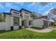 Beautiful modern home boasts a stylish design with a contrasting color scheme and neatly landscaped front yard at 1213 E Lemon St, Tarpon Springs, FL 34689