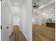 Bright hallway leading into an open layout living area with modern hardwood floors and recessed lighting at 1213 E Lemon St, Tarpon Springs, FL 34689