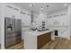 Modern kitchen features white cabinets, stainless steel appliances, an island with a unique wooden base, and pendant lighting at 1213 E Lemon St, Tarpon Springs, FL 34689