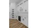 Wet bar featuring white cabinets, wine storage and quartz countertops at 1213 E Lemon St, Tarpon Springs, FL 34689