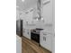 Kitchen with stainless appliances, white cabinets and quartz countertops at 1213 E Lemon St, Tarpon Springs, FL 34689