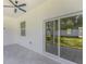 Covered patio with ceiling fan, glass sliding doors, and neutral toned tile at 1213 E Lemon St, Tarpon Springs, FL 34689