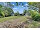 Expansive backyard showcasing the home's exterior, storage shed, and serene outdoor space at 1237 Oak Valley Dr, Seffner, FL 33584