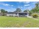 Large backyard featuring well-maintained green grass and a cozy screened in patio for outdoor relaxation at 1237 Oak Valley Dr, Seffner, FL 33584