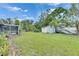 Lush backyard with a storage shed, screened-in porch, and plenty of room for gardening at 1237 Oak Valley Dr, Seffner, FL 33584