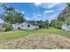 View of the expansive backyard with green grass and mature trees, providing plenty of space at 1237 Oak Valley Dr, Seffner, FL 33584