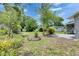 Well-maintained backyard with a shed, mature trees, and lush greenery, offering privacy and space at 1237 Oak Valley Dr, Seffner, FL 33584
