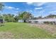 Spacious backyard featuring a shed, partial fence, and lush lawn, perfect for outdoor activities at 1237 Oak Valley Dr, Seffner, FL 33584