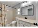 Clean bathroom with a single sink vanity, framed mirror, window, and a shower with seashell-themed curtain at 1237 Oak Valley Dr, Seffner, FL 33584