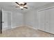 Neutral bedroom featuring tile floors, a ceiling fan, and a double-door closet at 1237 Oak Valley Dr, Seffner, FL 33584