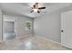 This bright bedroom features neutral walls, tile flooring, a ceiling fan, and a window for natural light at 1237 Oak Valley Dr, Seffner, FL 33584