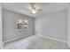 Simple bedroom with gray walls, tile flooring, window, and a ceiling fan at 1237 Oak Valley Dr, Seffner, FL 33584