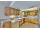 Well-lit kitchen featuring wood cabinetry, tile flooring, and stainless steel appliances at 1237 Oak Valley Dr, Seffner, FL 33584