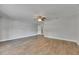 Spacious living room featuring wood-look floors, neutral walls, and a ceiling fan for comfortable living at 1237 Oak Valley Dr, Seffner, FL 33584
