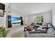 Open concept living room featuring a large sectional sofa and tiled floors at 1237 Oak Valley Dr, Seffner, FL 33584