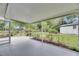 Enclosed patio is perfect for enjoying outdoor views of the green yard and shed at 1237 Oak Valley Dr, Seffner, FL 33584