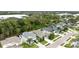Aerial view of home featuring manicured lawns, mature trees, and an attractive blue exterior at 1237 Windy Bay Shl, Tarpon Springs, FL 34689