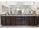 Double sink bathroom with two mirrors and granite countertops at 1237 Windy Bay Shl, Tarpon Springs, FL 34689