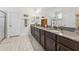 Bathroom featuring double sinks, a walk-in shower, and plenty of counter space at 1237 Windy Bay Shl, Tarpon Springs, FL 34689