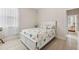 Bright bedroom featuring a bed with patterned comforter, hardwood floors, and a sun-filled window at 1237 Windy Bay Shl, Tarpon Springs, FL 34689