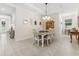 Bright dining room with white-washed table, pendant lighting, and neutral color scheme, perfect for gatherings at 1237 Windy Bay Shl, Tarpon Springs, FL 34689