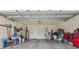 Spacious garage with ample storage space, including storage tubs and an easy access entry door at 1237 Windy Bay Shl, Tarpon Springs, FL 34689