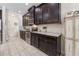 Modern kitchen with dark wood cabinets, stainless steel appliances, and ample counter space at 1237 Windy Bay Shl, Tarpon Springs, FL 34689